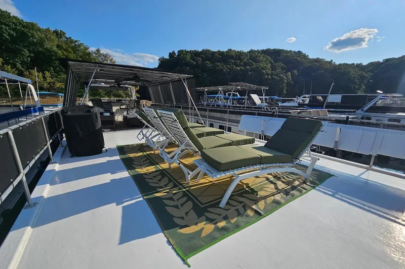 Slide: The Image of Sun deck of 2000 Sumerset 16x75 houseboat with lounge chairs and canopy. - 63