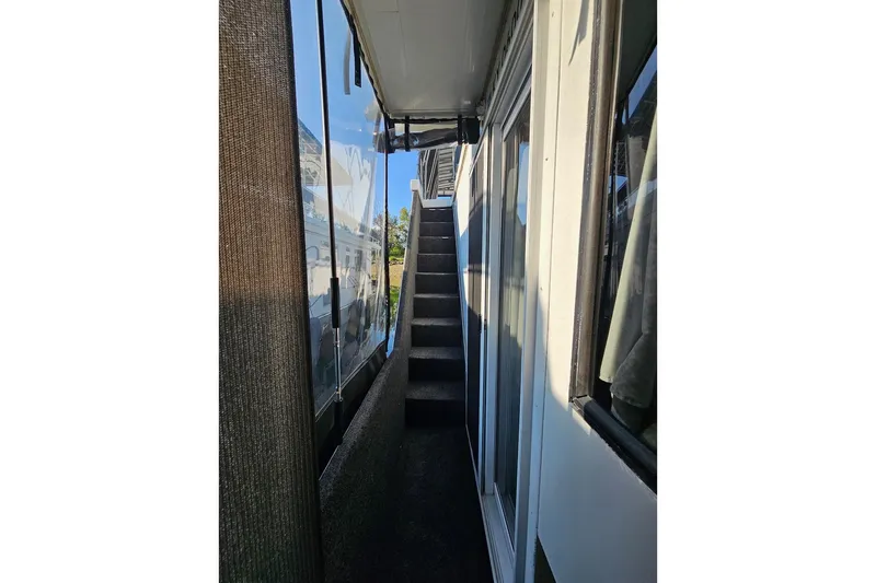 Slide: The Image of Narrow walkway with stairs on a 2000 Sumerset 16x75 houseboat. - 66