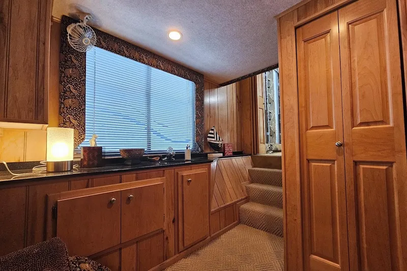 Slide: The Image of Interior of 2000 Sumerset 16x75 houseboat with wood paneling and cozy decor. - 71