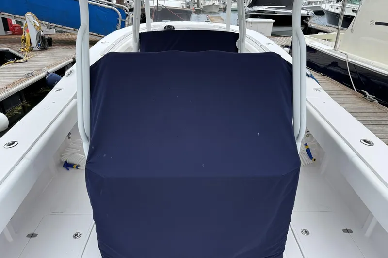 Slide: The Image of 2018 Southport 33 FE boat with navy cover, docked at marina. - 10