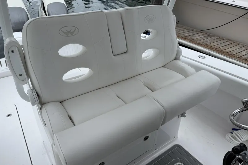 Slide: The Image of 2018 Southport 33 FE boat seat with white cushioned design and circular cutouts. - 14