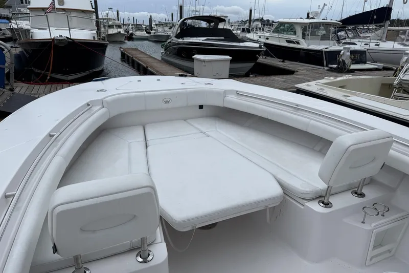 Slide: The Image of 2018 Southport 33 FE boat with white seating, docked at a marina. - 17
