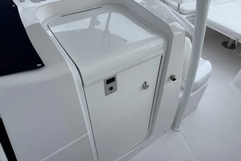 Slide: The Image of 2018 Southport 33 FE boat interior with white storage compartment and seating area. - 21