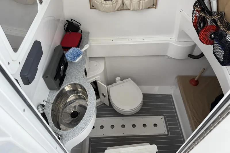 Slide: The Image of 2018 Southport 33 FE boat bathroom with sink, toilet, and storage. - 23