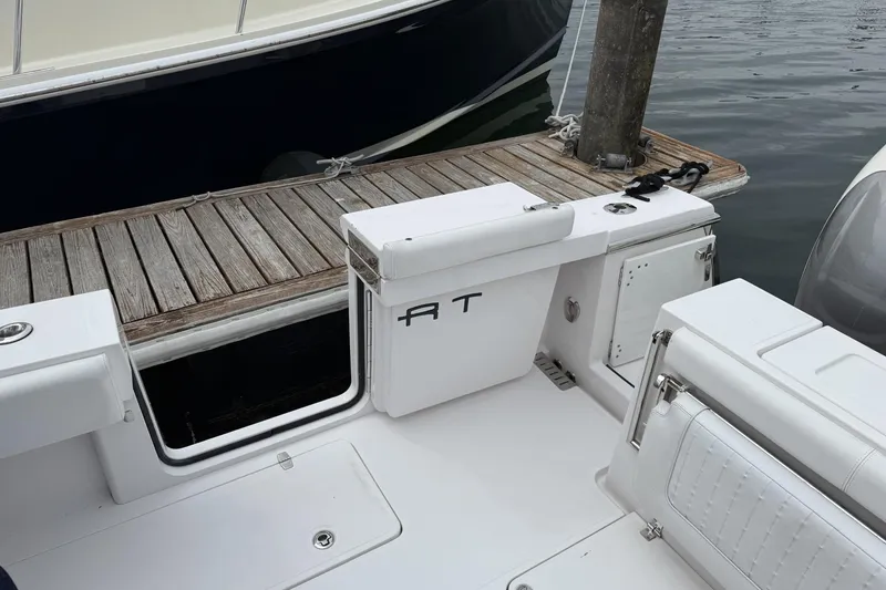 Slide: The Image of 2018 Southport 33 FE boat interior with white seating and wooden dock. - 6