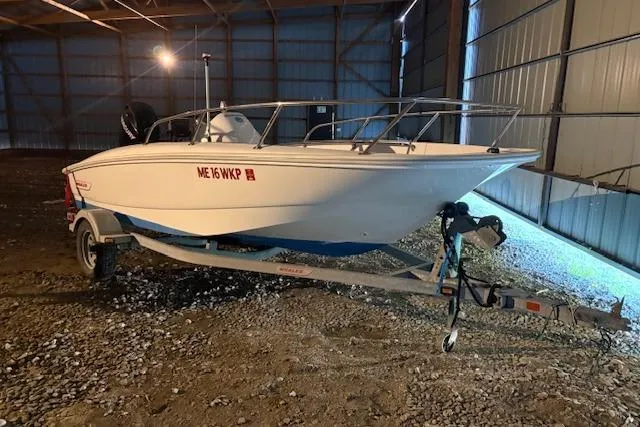 Slide: The Image of 2010 Boston Whaler 150 Super Sport boat on trailer in storage facility. - 3