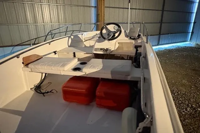 Slide: The Image of 2010 Boston Whaler 150 Super Sport boat interior with seating and storage compartments. - 7