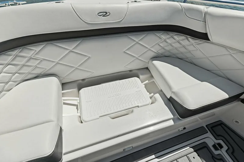 Slide: The Image of 2022 Regal 33 OBX boat interior with diamond-stitched seating and integrated cooler. - 14