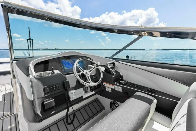 Slide: The Image of 2022 Regal 33 OBX boat cockpit with modern steering and navigation system. - 15