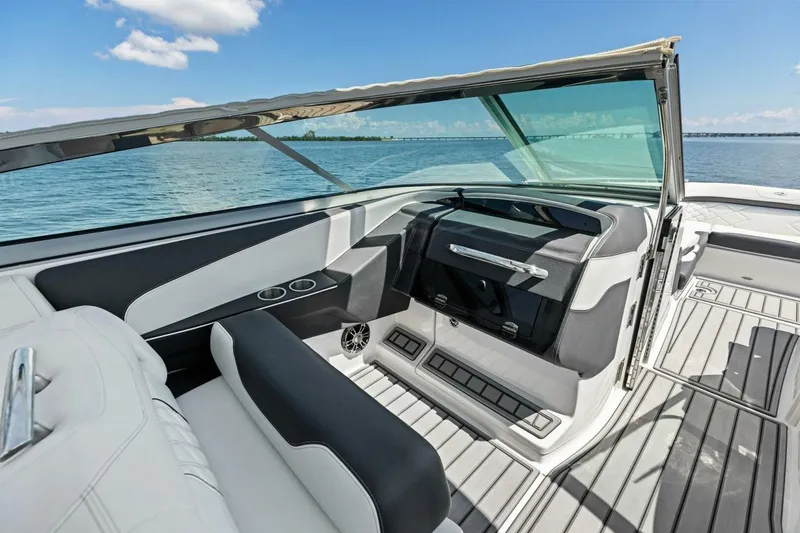 Slide: The Image of 2022 Regal 33 OBX boat interior with sleek seating and open water view. - 17
