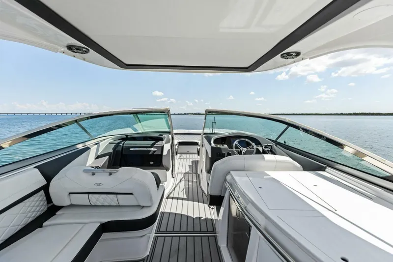 Slide: The Image of 2022 Regal 33 OBX boat interior with luxurious seating and ocean view. - 18