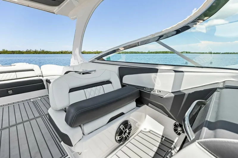 Slide: The Image of 2022 Regal 33 OBX boat interior with luxurious seating and scenic water view. - 20