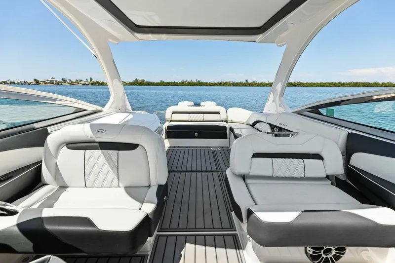 Slide: The Image of 2022 Regal 33 OBX boat interior with luxurious seating and scenic water view. - 22