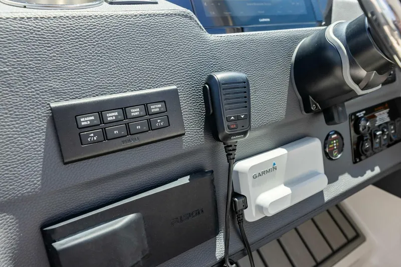 Slide: The Image of 2022 Regal 33 OBX dashboard featuring Garmin marine electronics and Yamaha controls. - 31