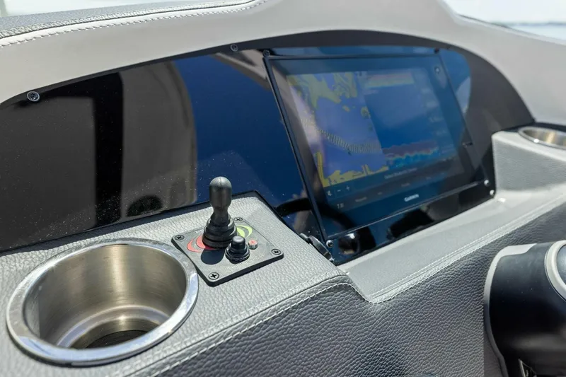 Slide: The Image of Dashboard of 2022 Regal 33 OBX boat with navigation screen and controls. - 32