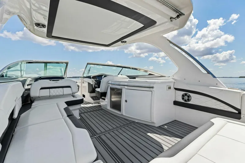 Slide: The Image of 2022 Regal 33 OBX boat interior with luxurious seating and modern design on a sunny day. - 34