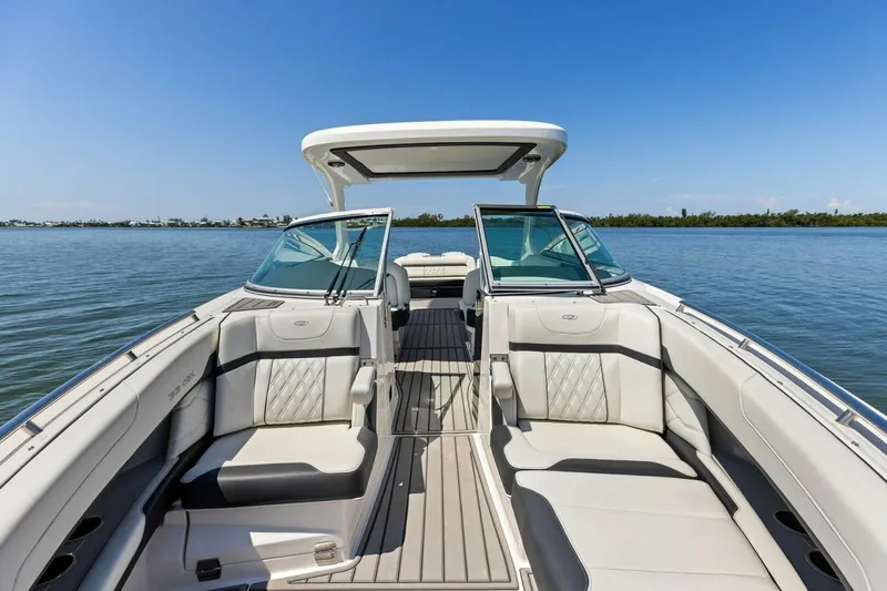 Slide: The Image of 2022 Regal 33 OBX boat interior with luxurious seating on calm water. - 37