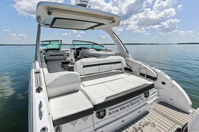 Slide: The Image of 2022 Regal 33 OBX boat with luxurious seating on calm waters. - 39