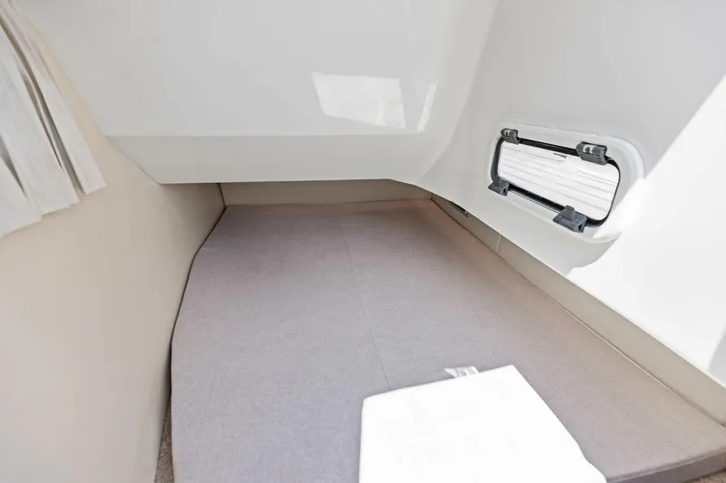 Slide: The Image of 2022 Regal 33 OBX cabin interior with bed and window. - 45