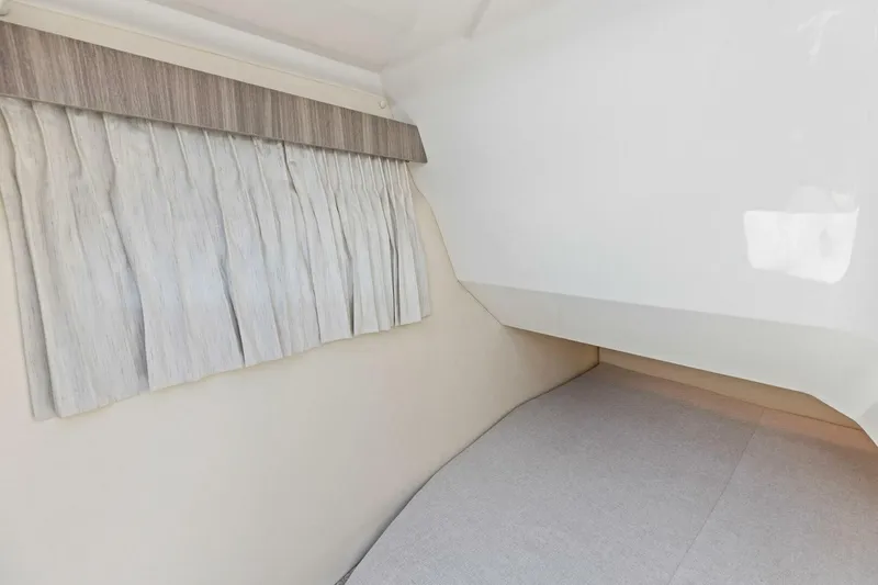Slide: The Image of 2022 Regal 33 OBX interior cabin with curtain and bed. - 46