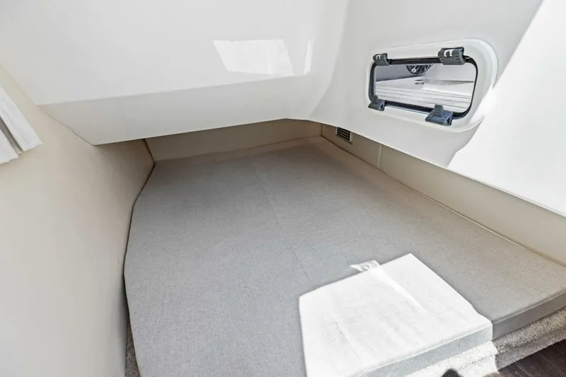 Slide: The Image of 2022 Regal 33 OBX cabin interior with window and cushioned sleeping area. - 47