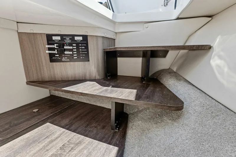 Slide: The Image of 2022 Regal 33 OBX interior with wooden steps and control panel. - 48