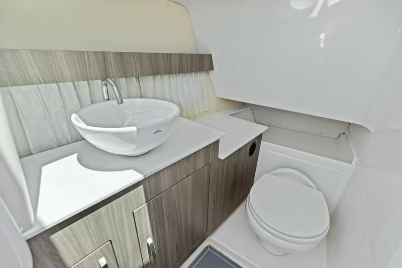 Slide: The Image of 2022 Regal 33 OBX boat bathroom with modern sink and toilet. - 5