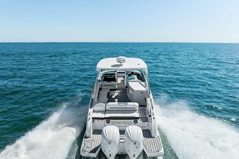 Slide: The Image of 2022 Regal 33 OBX boat cruising on open sea, rear view. - 57