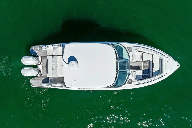 Slide: The Image of Overhead view of 2022 Regal 33 OBX boat on green water. - 6