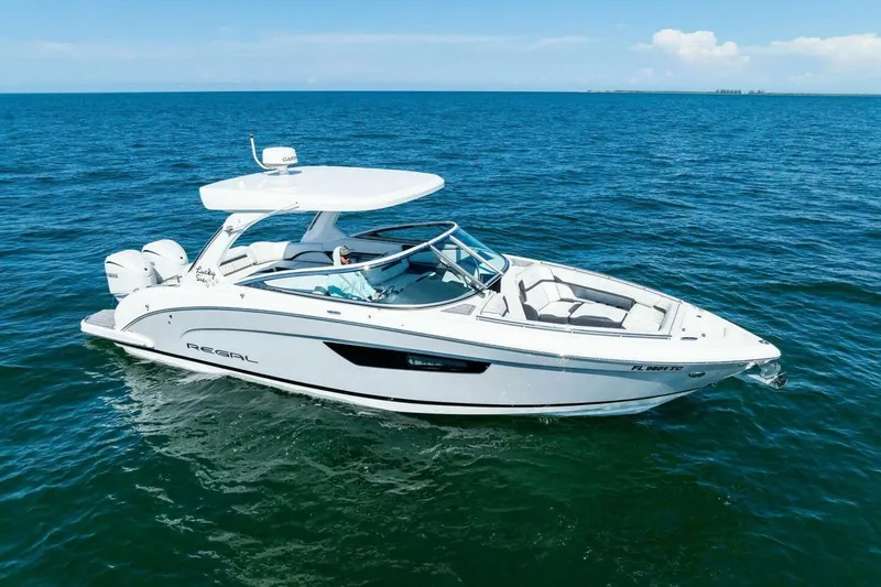 Slide: The Image of 2022 Regal 33 OBX boat cruising on open blue water. - 68