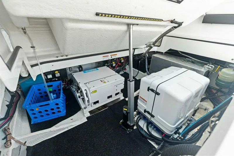 Slide: The Image of Engine compartment of 2022 Regal 33 OBX boat, featuring equipment and storage. - 7