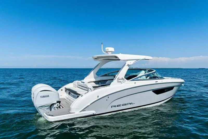 Slide: The Image of 2022 Regal 33 OBX boat on open water with Yamaha engine. - 70
