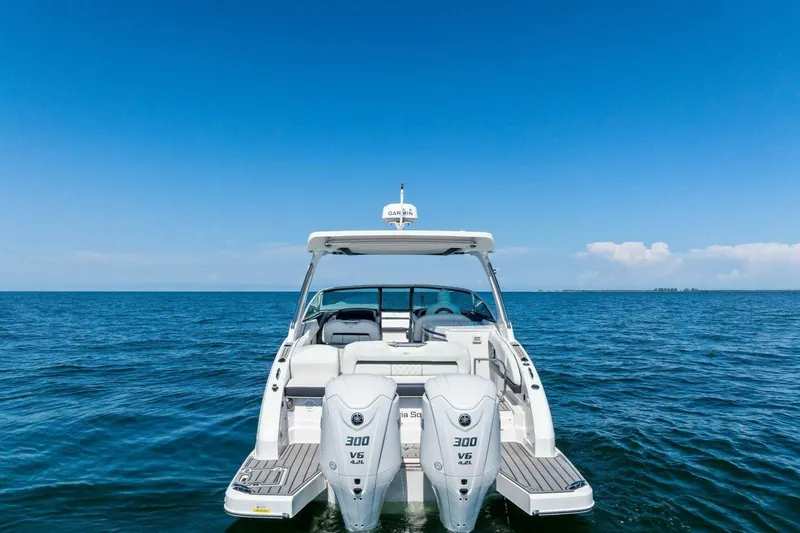 Slide: The Image of 2022 Regal 33 OBX boat on open water under clear blue sky. - 71