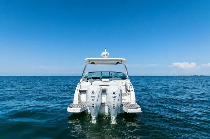 Slide: The Image of 2022 Regal 33 OBX boat on open water with twin outboard engines. - 72