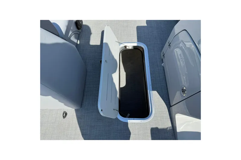 Slide: The Image of 2025 Bentley Pontoons Legacy 243 QSB interior storage compartment open on deck. - 10