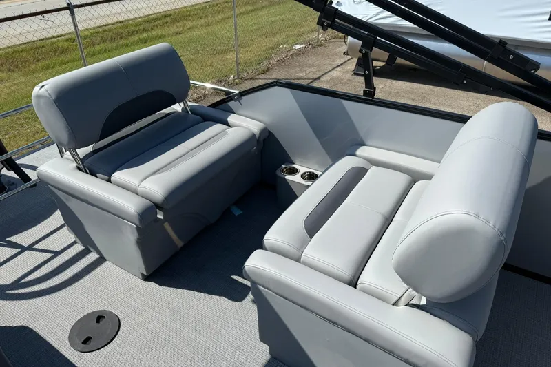 Slide: The Image of 2025 Bentley Pontoons Legacy 243 QSB interior with gray seating and cup holders. - 13