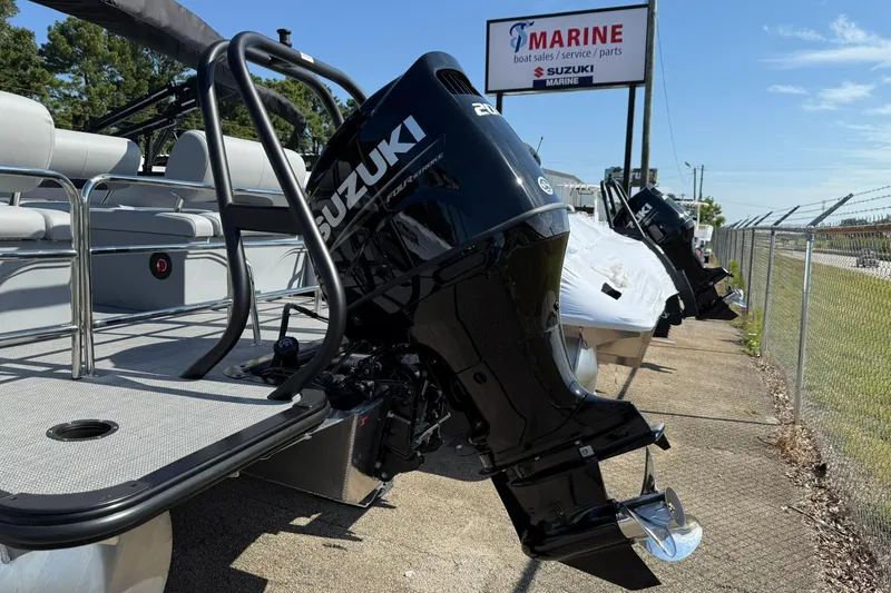 Slide: The Image of 2025 Bentley Pontoons Legacy 243 QSB with Suzuki outboard motor at marine dealership. - 17
