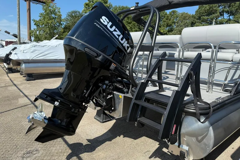 Slide: The Image of 2025 Bentley Pontoons Legacy 243 QSB with Suzuki outboard motor, docked and ready. - 19