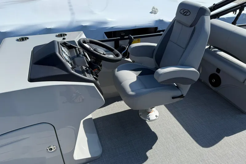 Slide: The Image of 2025 Bentley Pontoons Legacy 243 QSB helm with luxurious captain's chair and steering console. - 5