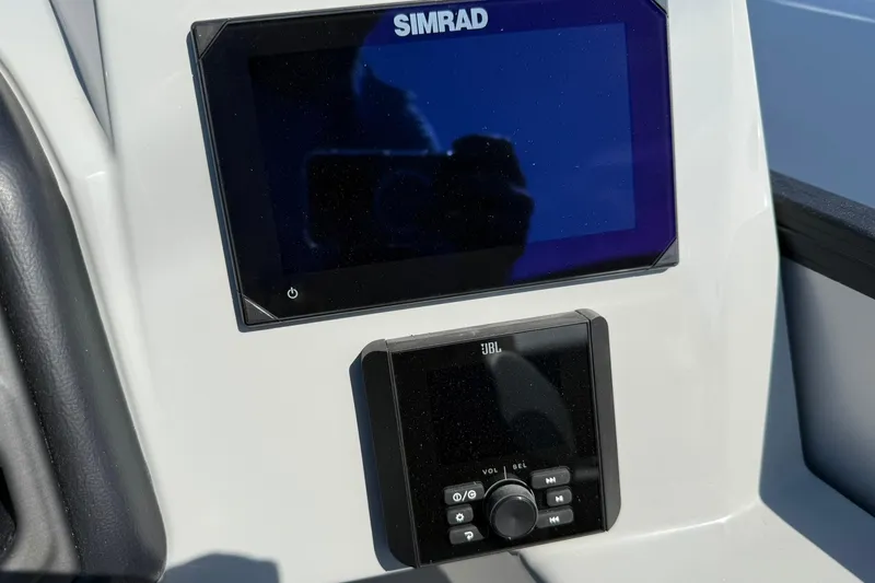 Slide: The Image of 2025 Bentley Pontoons Legacy 243 QSB dashboard with Simrad and JBL controls. - 7