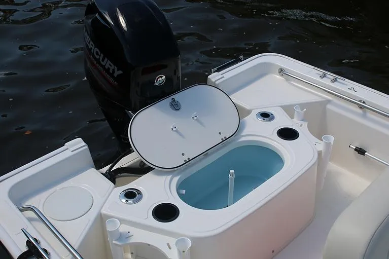 Slide: The Image of Manufacturer Provided Image: 2023 Boston Whaler 150 Montauk boat with open livewell and Mercury outboard motor. - 13