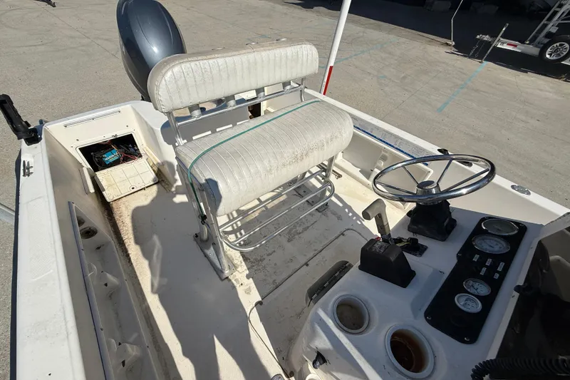Slide: The Image of 2004 Sea Hunt Triton 186 boat interior with steering wheel and seating. - 11