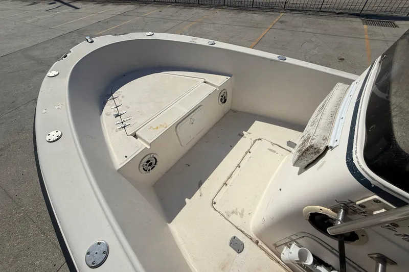 Slide: The Image of 2004 Sea Hunt Triton 186 boat interior, featuring spacious deck and storage compartments. - 9