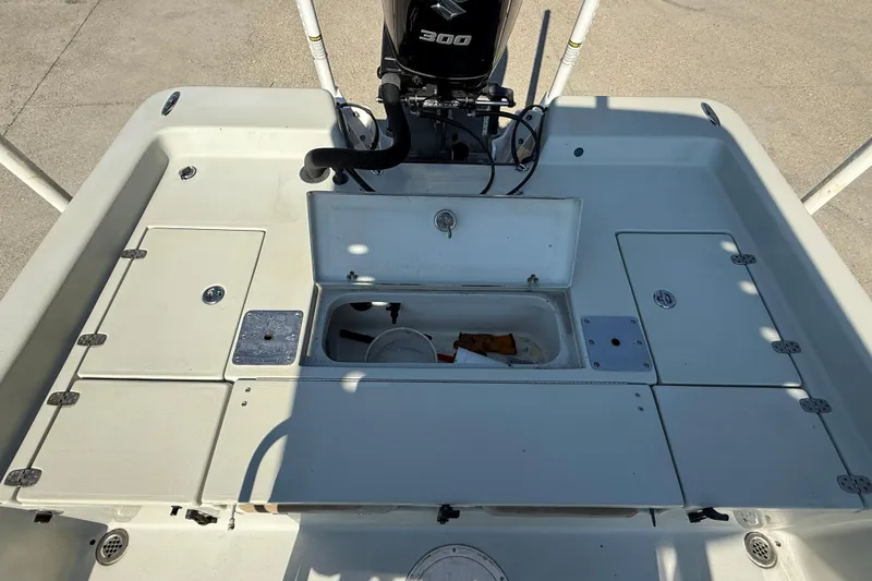 Slide: The Image of 2016 Blazer Bay 2420 Professional boat deck with storage compartments and motor. - 13