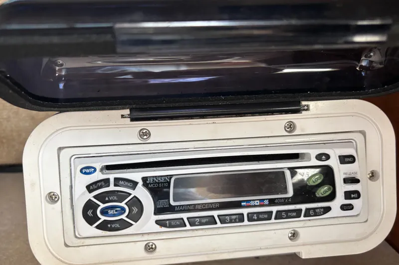 Slide: The Image of Marine stereo system in a 2000 Shamrock 260 Express boat, featuring Jensen MCD 5110 model. - 14