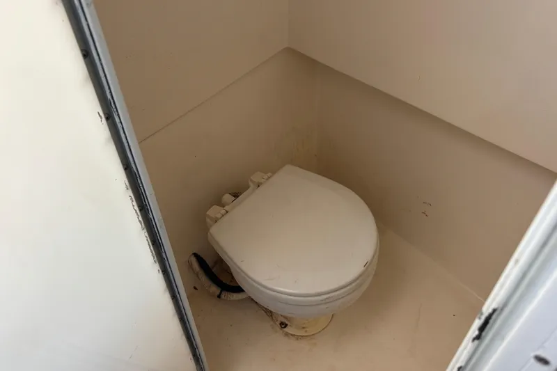 Slide: The Image of Compact marine toilet in a 2000 Shamrock 260 Express boat. - 15