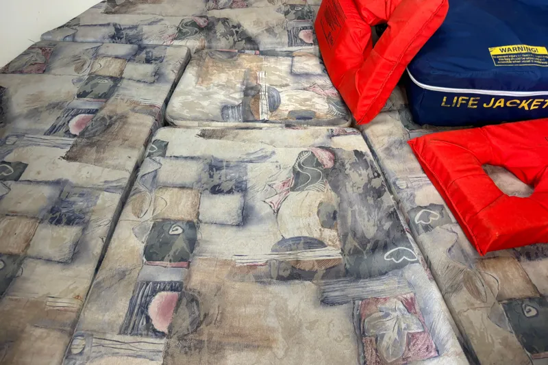 Slide: The Image of Cushioned interior of 2000 Shamrock 260 Express with life jackets. - 21