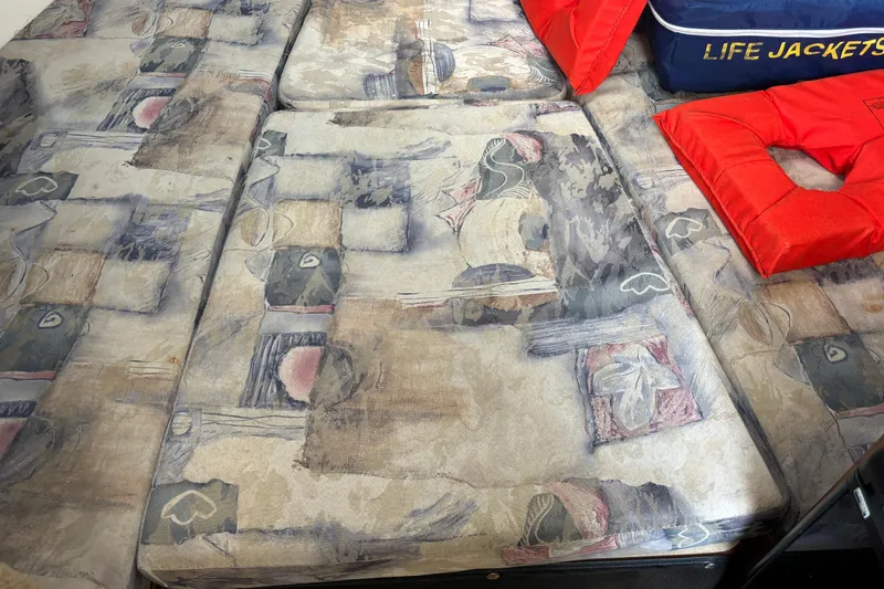 Slide: The Image of Cushioned interior of 2000 Shamrock 260 Express boat with life jackets. - 22