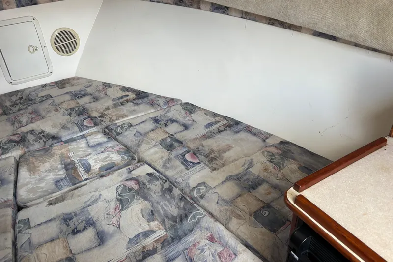 Slide: The Image of Interior cabin of 2000 Shamrock 260 Express boat with patterned cushions. - 23