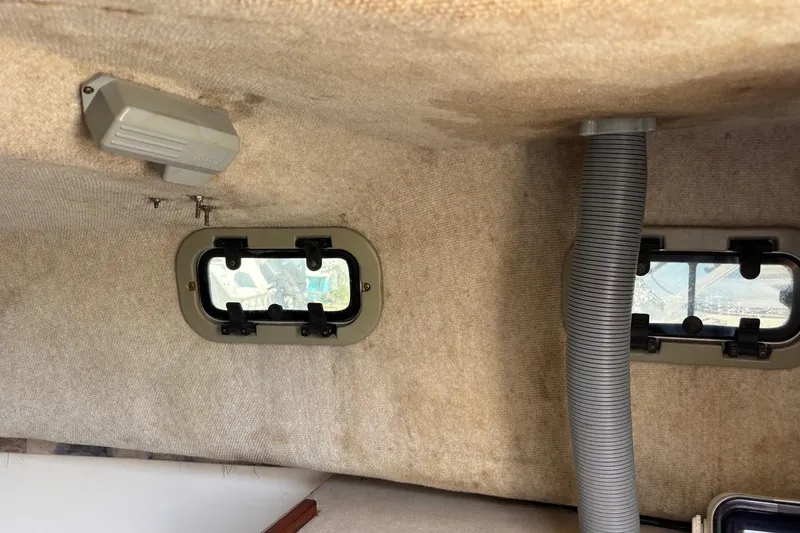 Slide: The Image of Interior of 2000 Shamrock 260 Express boat with portholes and ventilation hose. - 25